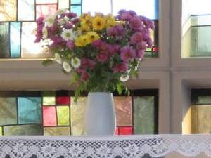 weiße Vase mit Blumen auf Altar